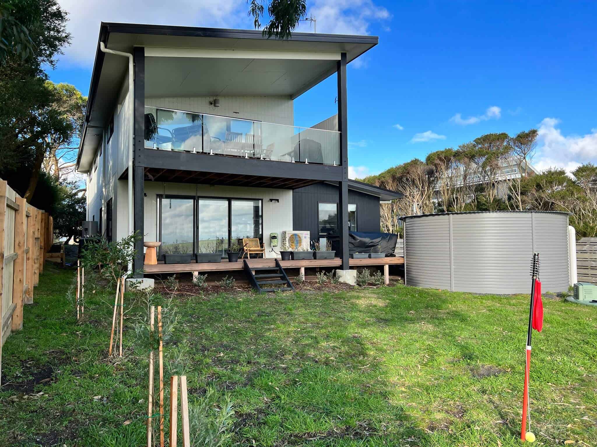 Rear yard looking at house with decking and dining area