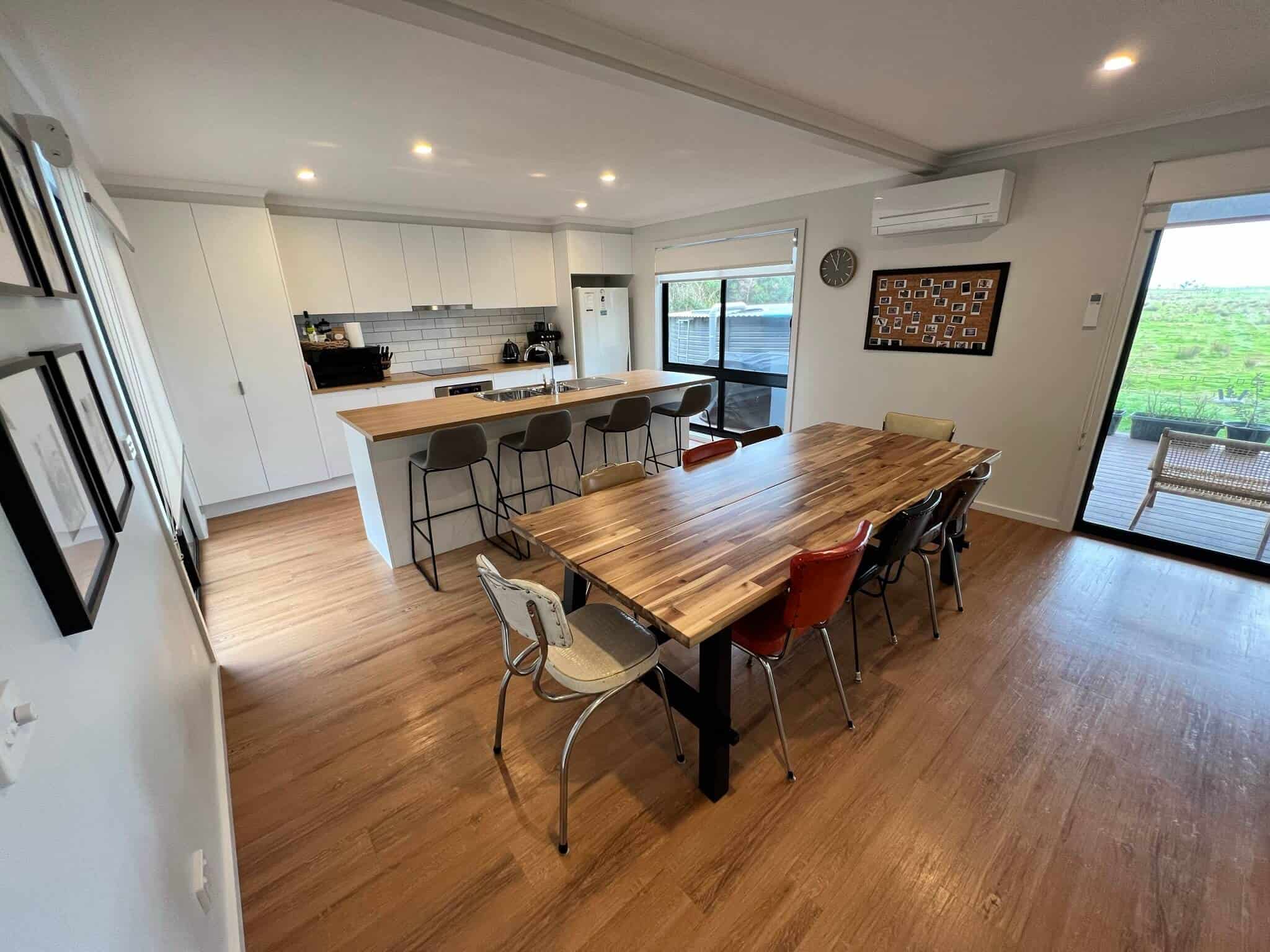 Dining area and kitchen with kettle and coffee machine, fridge and microwave