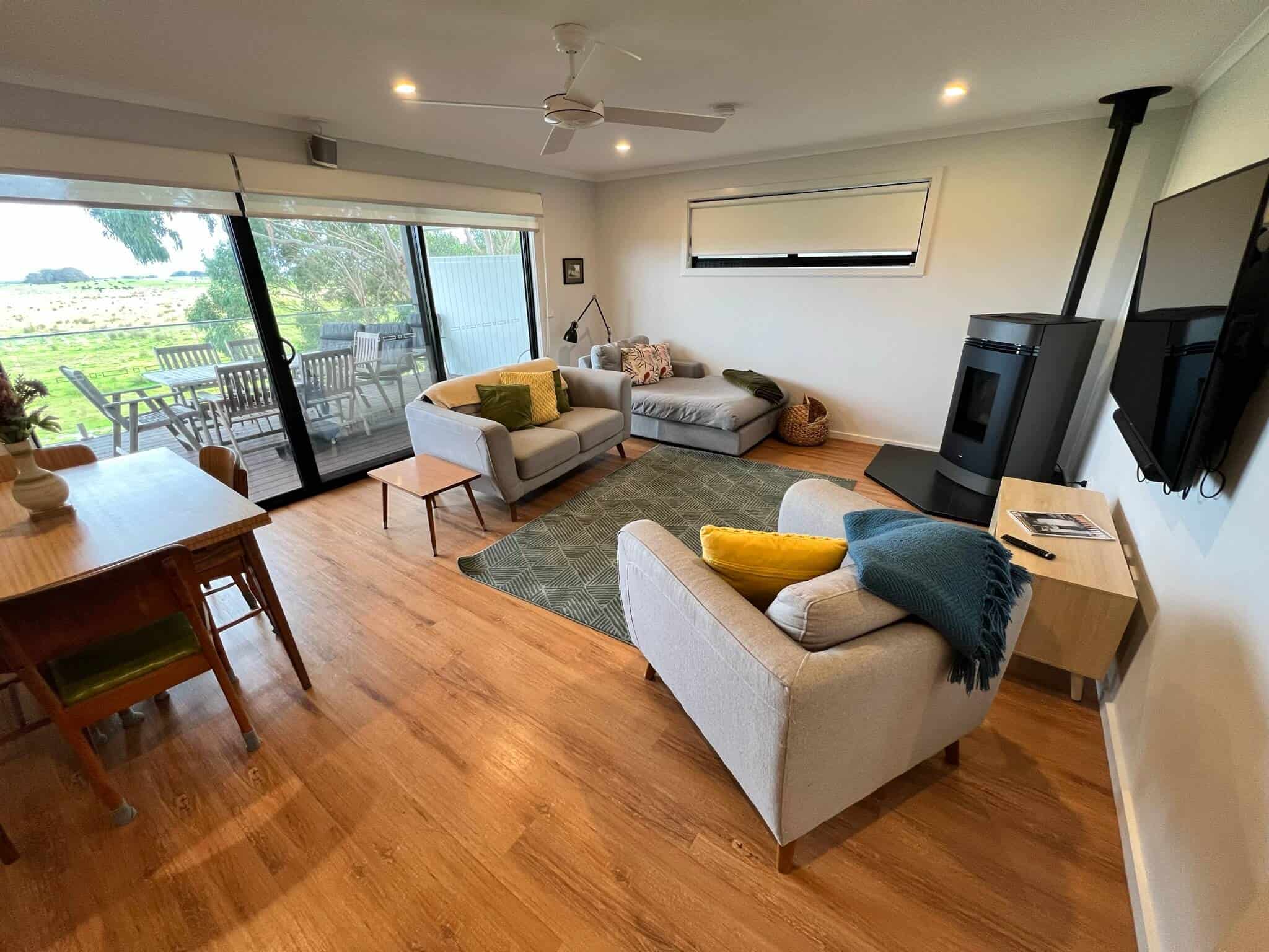 Upstairs lounge room with TV, wood heater and board games