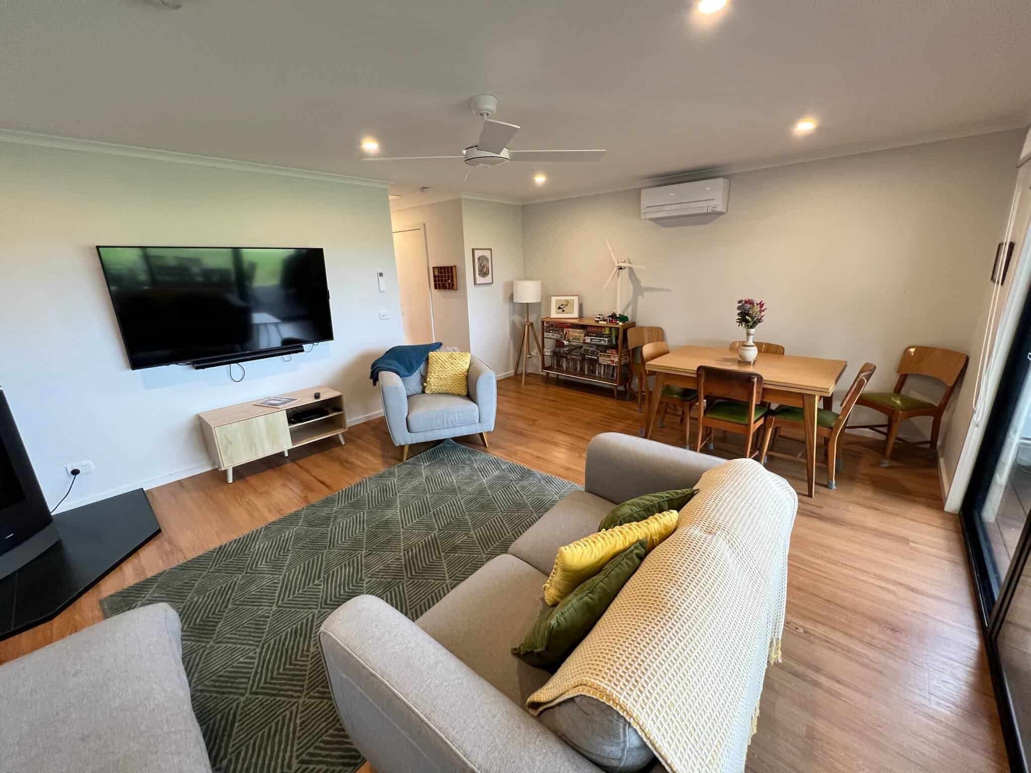 Upstairs lounge room with TV, wood heater and board games