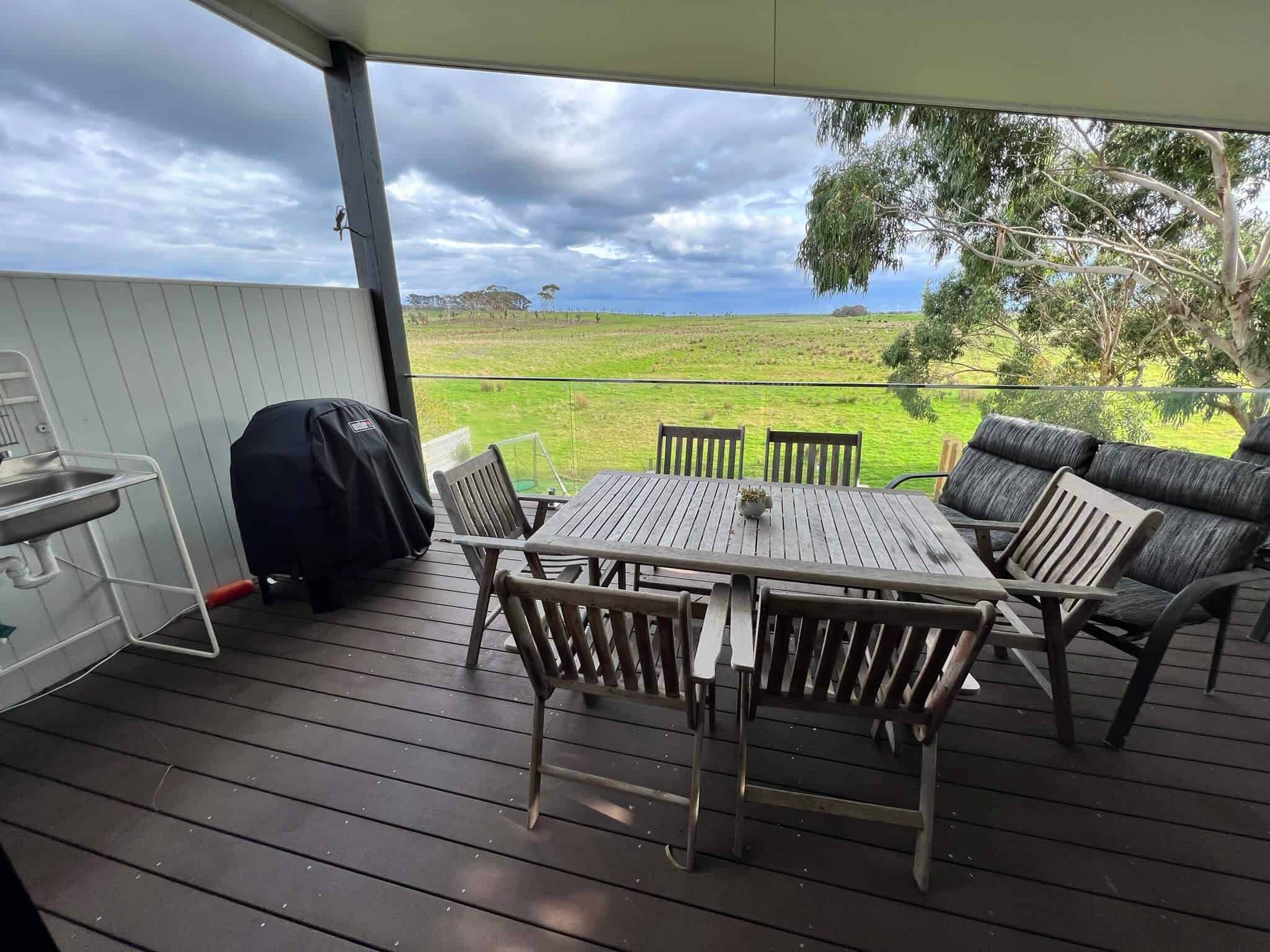 Balcony overlooking farmland with BBQ and kitchenette